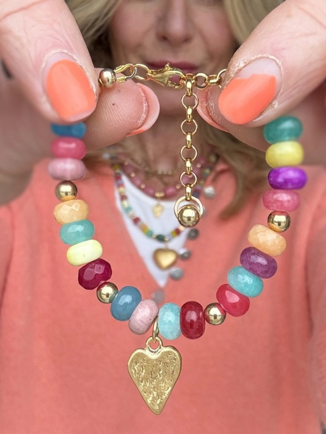 Candy girl beaded necklace with gemstones. A multicoloured gemstone beaded necklace shown with a heart charm