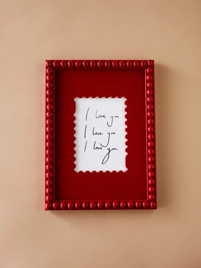 crimson red stamp shaped frame mount with red bobbin frame 