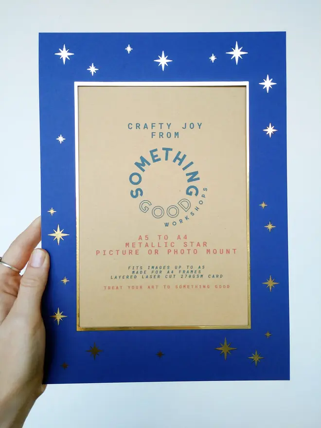 metallic star a5 / a4 christmas photo mount. blue mount photographed against grey background.