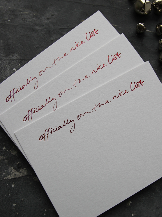 christmas notecard form Santa that says Officially On The Nice List in red foil with an envelope that says North Pole Mail