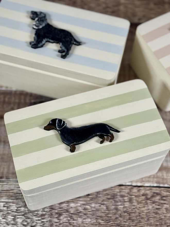 Green and White striped wooden hinged memory keepsake box with a hand- painted black and tan dachshund on the lid