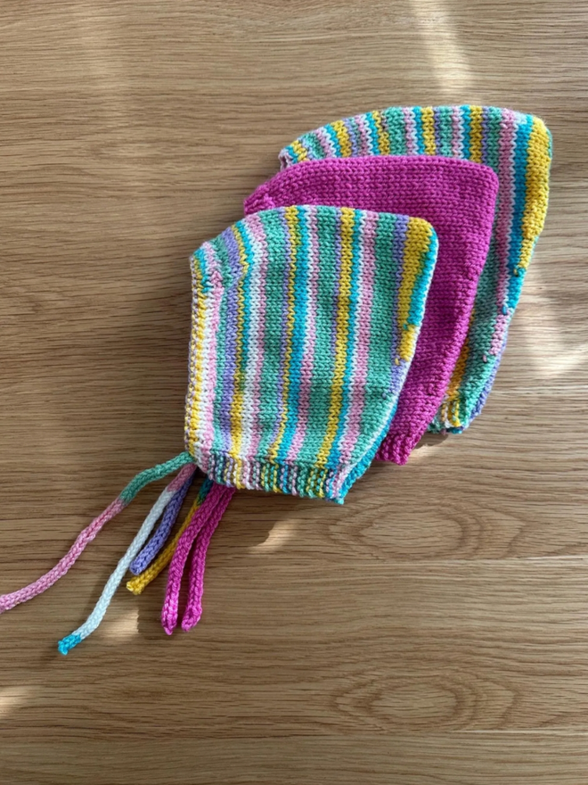 Pixie Bonnet. Three pixie bonnets showcasing the range of sizes available.