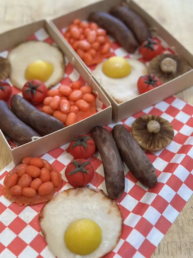 Brekkielicious Marzipan Box, sweet marzipan box displayed on a table surface. In the image are marzipan eggs, beans, mushrooms, tomatoes and sausages along with traditional red and white patterned cloth. 