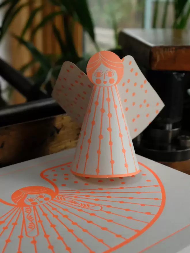 Letterpress angels in orange ink. 