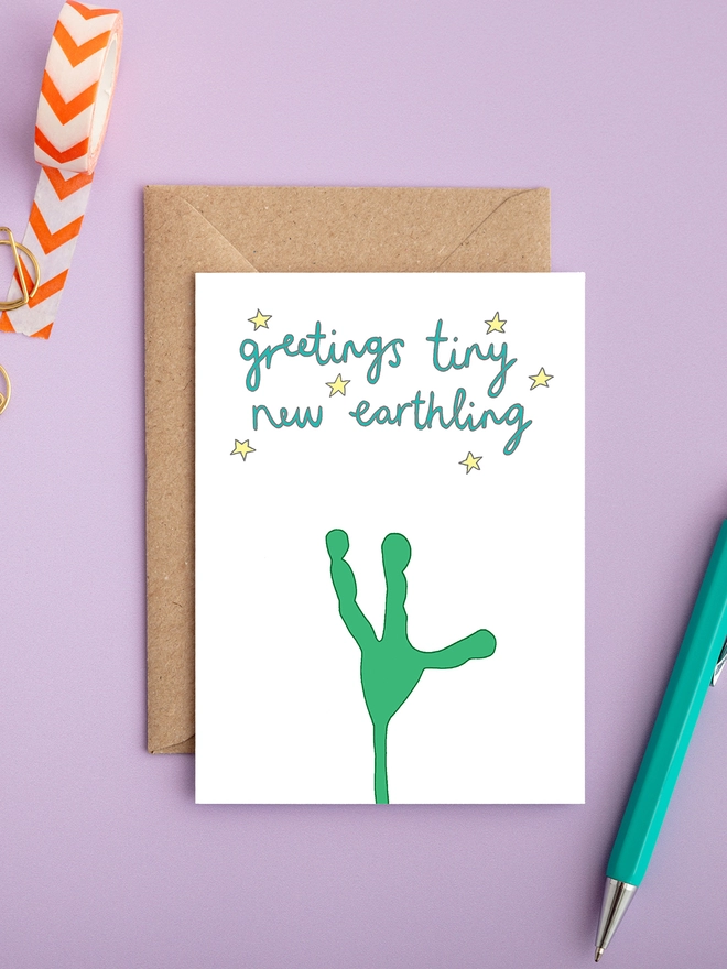 Humorous and funny gender neutral new baby card featuring alien hand