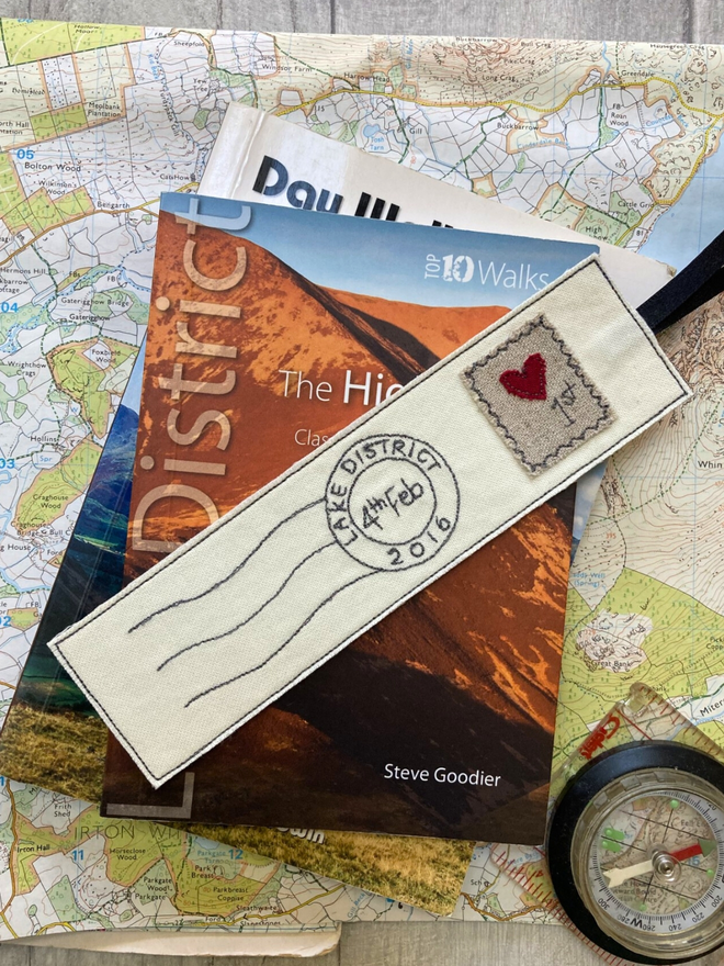 Embroidered Postmark Bookmark on book