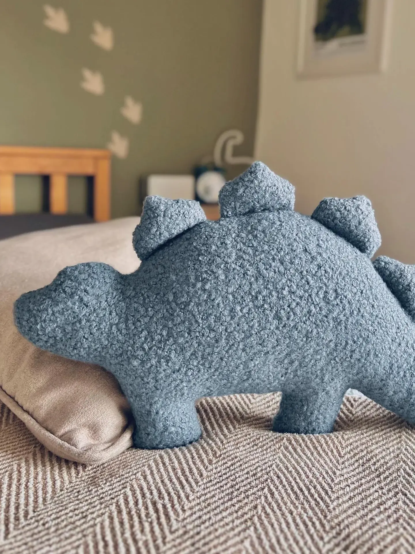 boucle dinosaur pillows. a blue stegosaurus cushion.