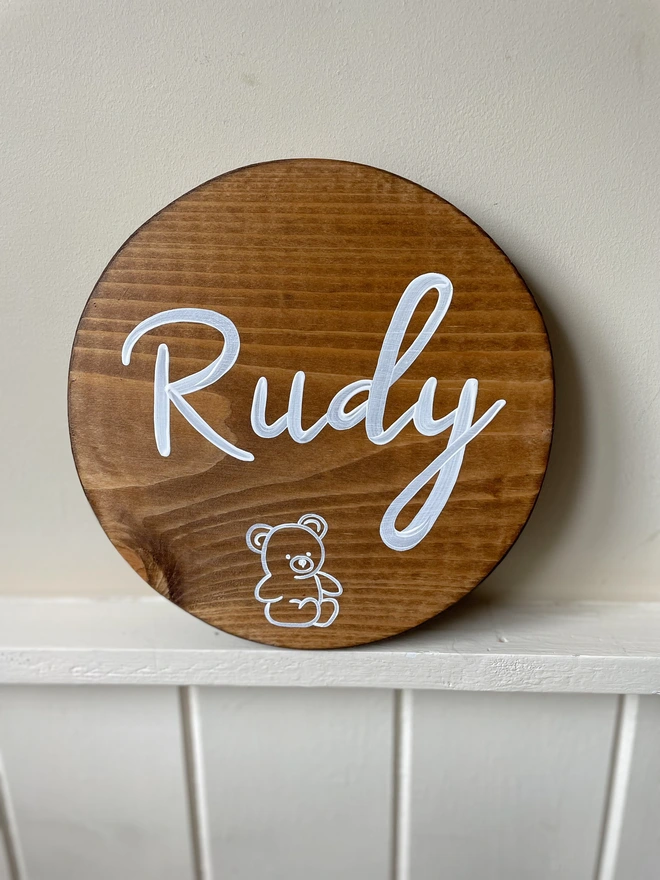 round wooden name sign