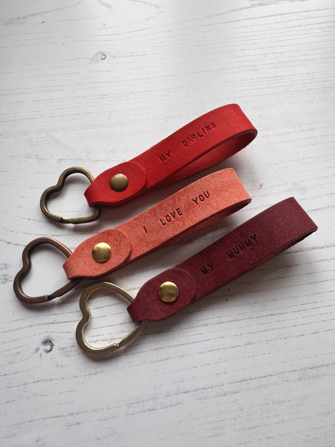 hand stamped leather keyrings with a heart metal ring.