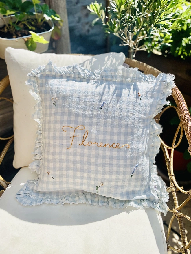 Blue gingham linen cushion with hand embroidered ditsy florals and personalised name