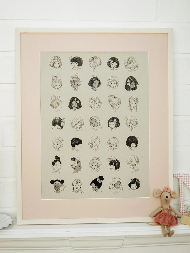 pretty framed vintage style illustration featuring vintage style childrens book drawings of girls with different hairbows. shown in a pink picture frame mount in a white frame propped on a mantle piece with a maileg mouse