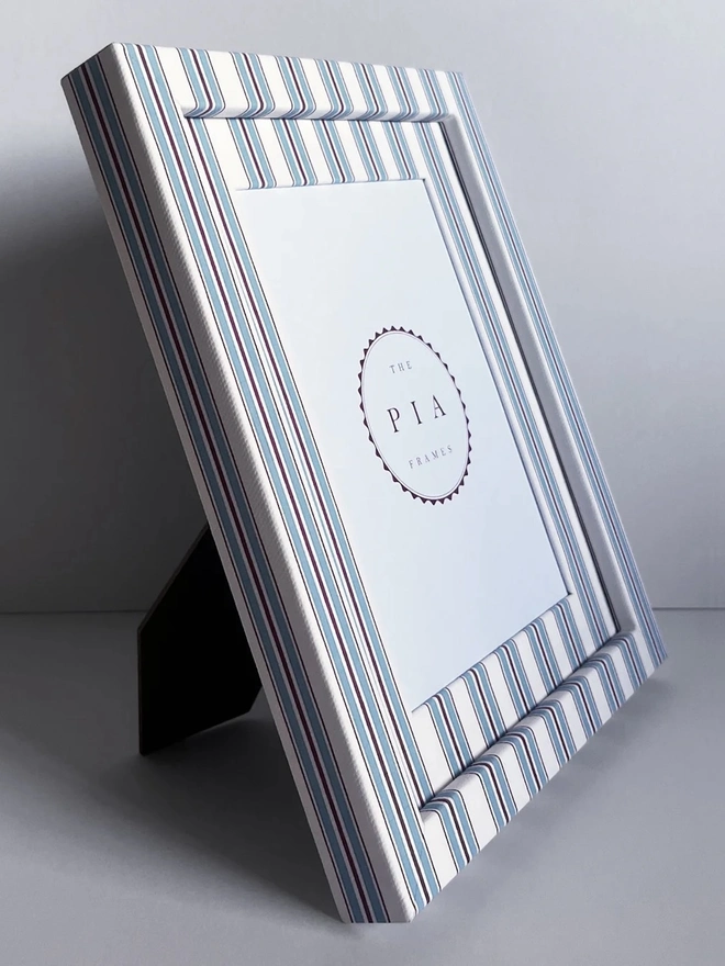 Sky & Scarlet Tailor Stripe Frame, a patterned colourful frame sitting on a plain white surface. 