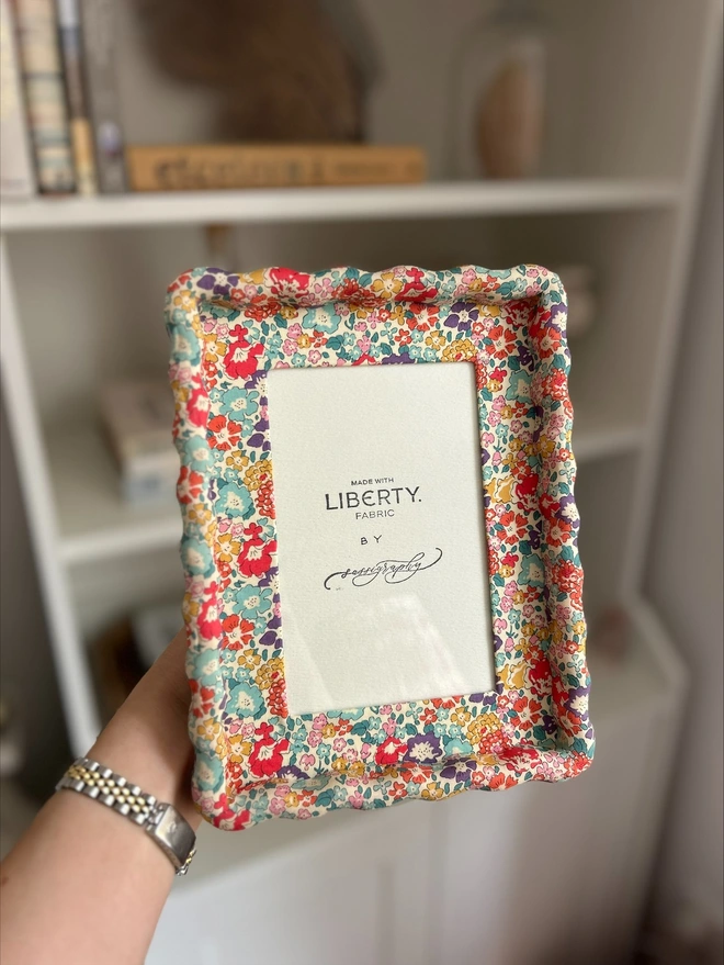 Liberty fabric covered wavy photo frame in hand