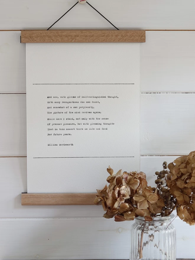 Hand typed wall hanging in a wooden print hanger