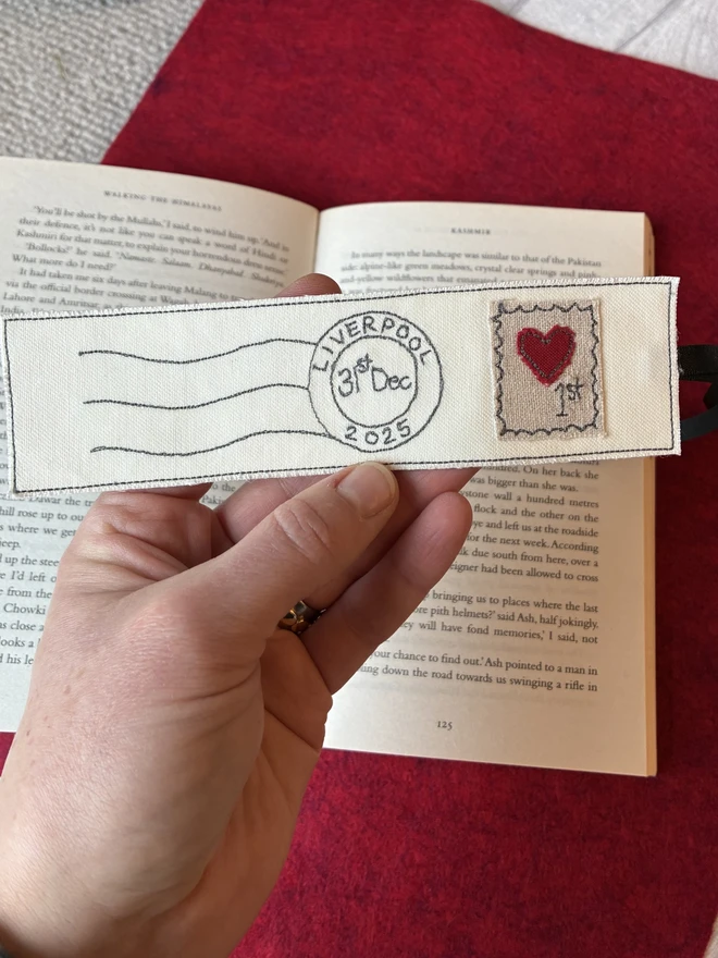 close up of embroidered postmark bookmark