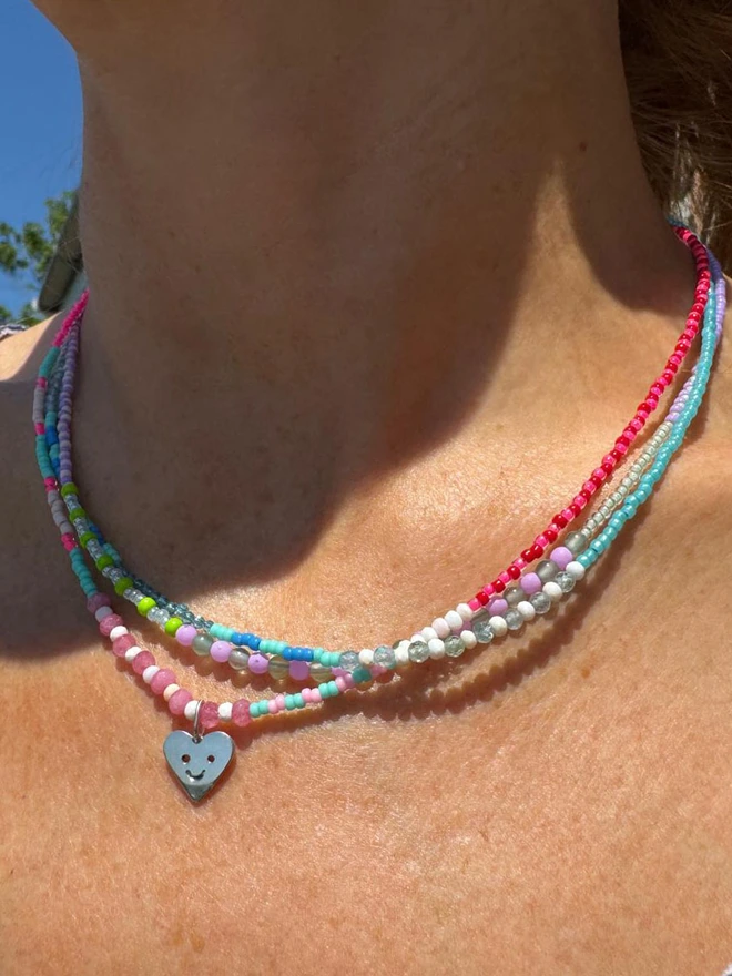 Stack of Beaded Charm necklaces
