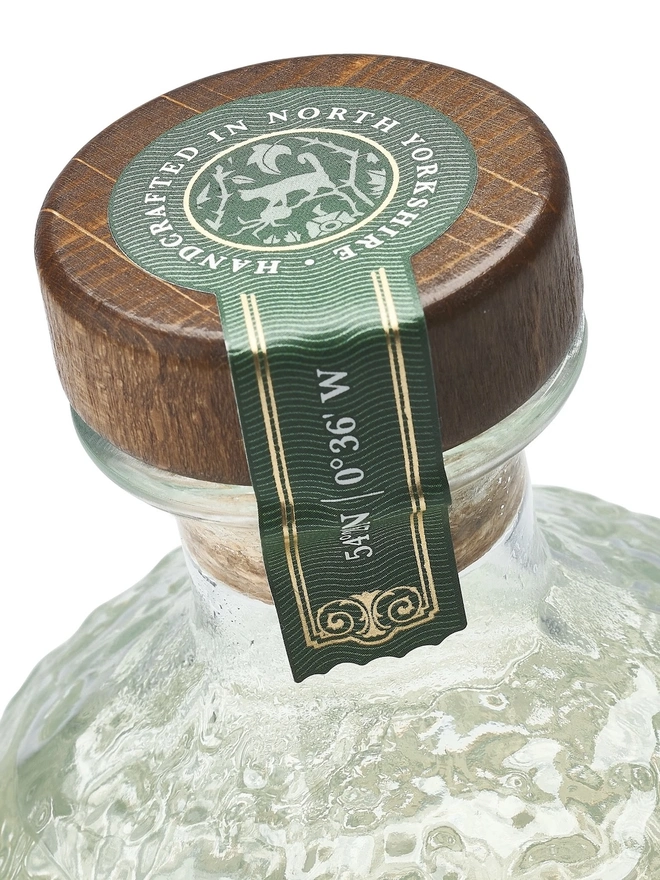 Wild Old Tom Edition Gin, a bottle of gin sitting on a plain white surface. 