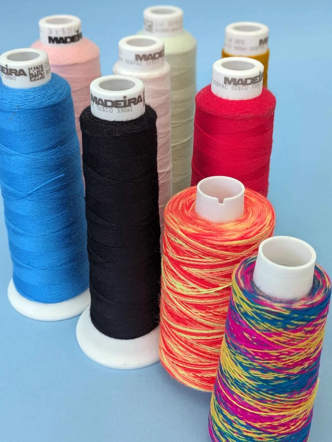 A range of embroidery threads presented on a blue background