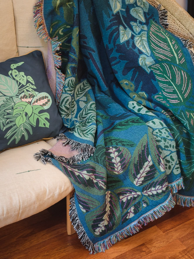 Indoor Jungle Window by Arcana seen laid out on a cream sofa.