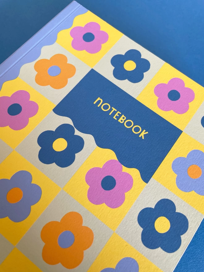Close up of colourful Raspberry Blossom A5 flower check design notebook