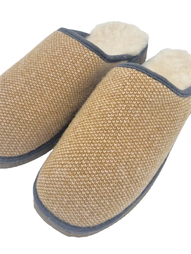 Lambswool & Sheepskin Slippers, a pair of colourful lambswool and sheepskin slippers sitting on a plain white surface. 