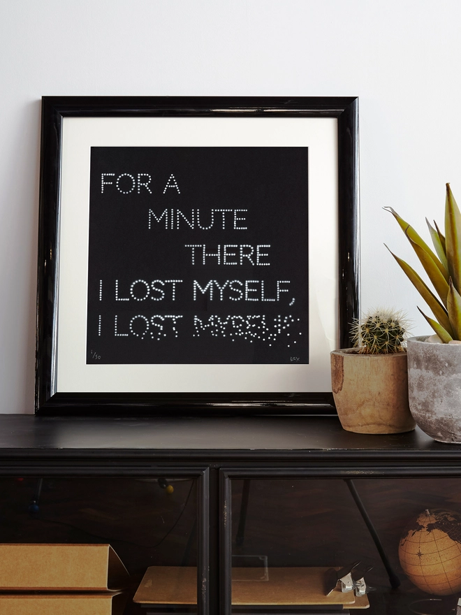 Music lyric art print on a shelf