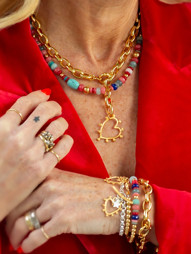 Bring playful energy to your jewellery collection with the Love Drunk Wrap Bracelet. This double wrap bracelet blends metal beads with vibrant jade and is finished with delicate heart and star charms for added meaning. A colourful stacking bracelet made for everyday confidence, connection and joyful self-expression.