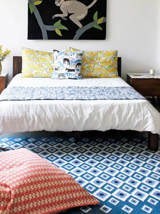 Evil Eye Flatweave Rug, a colourful rug in a living room. It is accompanied by other colourful household items. 
