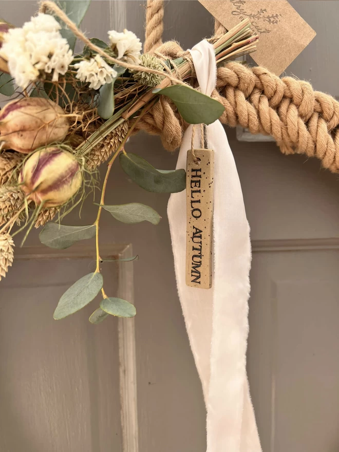 hello autumn ceramic tag tied on a rope wreath