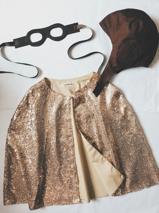 Gold sequin cape, vintage flying hat and leather goggles
