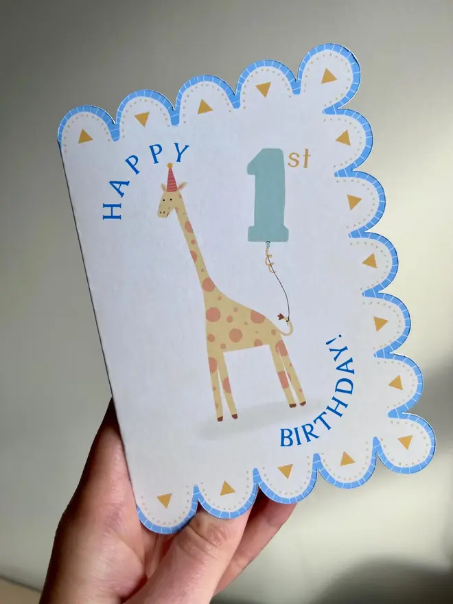 happy 1st birthday illustrated giraffe card. scallop edged card with illustrated giraffe.