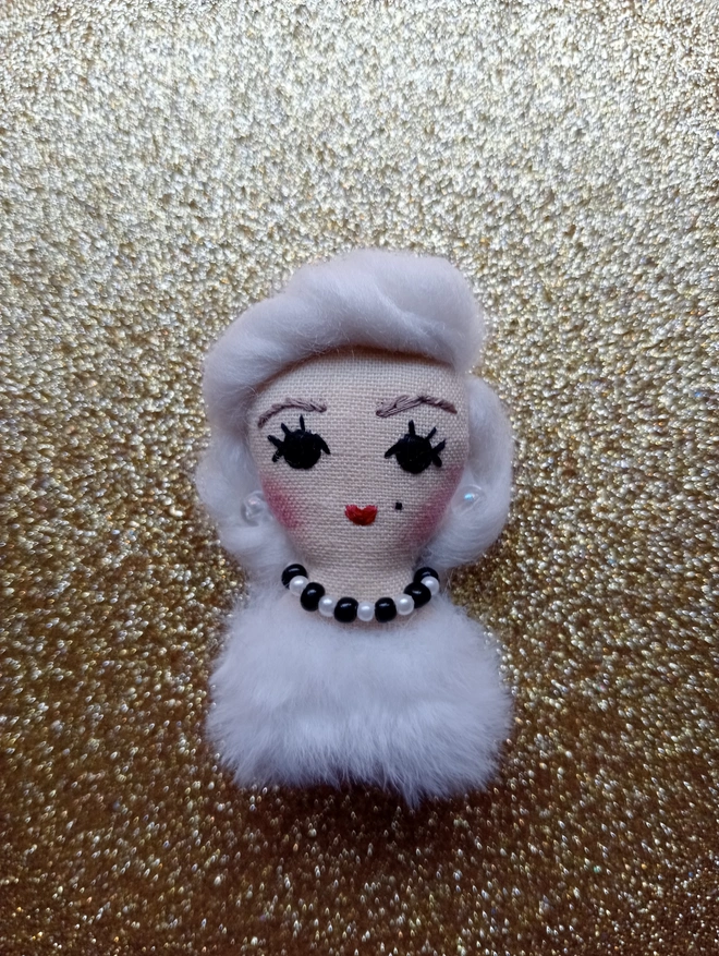 Marilyn Monroe in white fur with black and white pearl choker, hanging decoration 