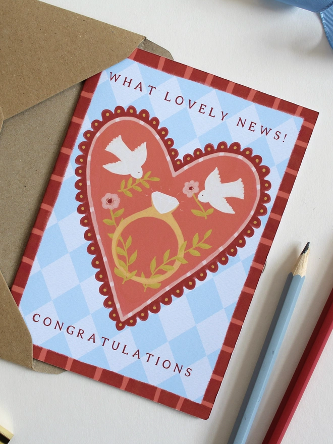 botanical engagement card featuring love birds on a big heart with a ring