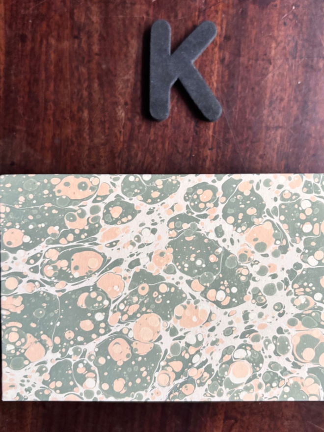 Matchbox Cover. A matchbox cover in K