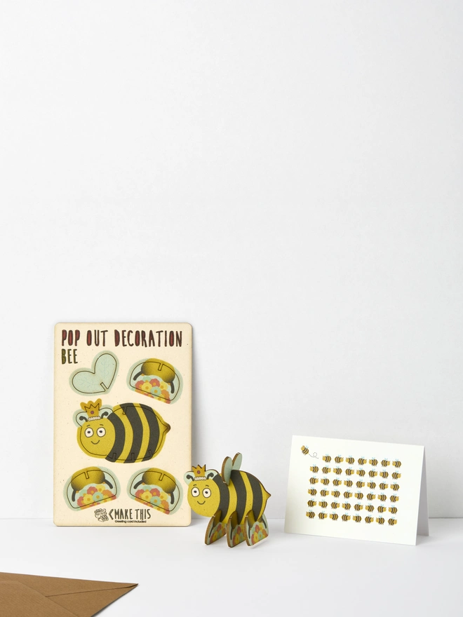 Bee decoration and Bee pattern greeting card and brown kraft envelope on a white background
