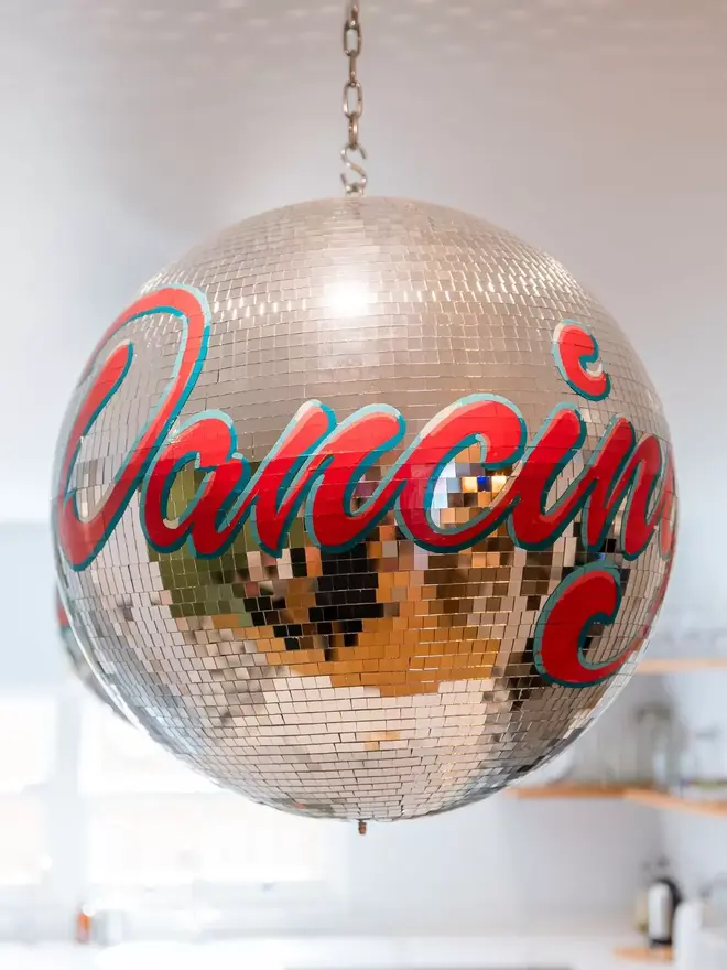 Red sign painted disco ball