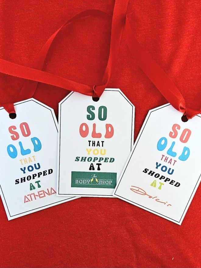 3 tags that say so old that you shopped at Athena Body Shop Dolcis in bright colourful letters with a red ribbon