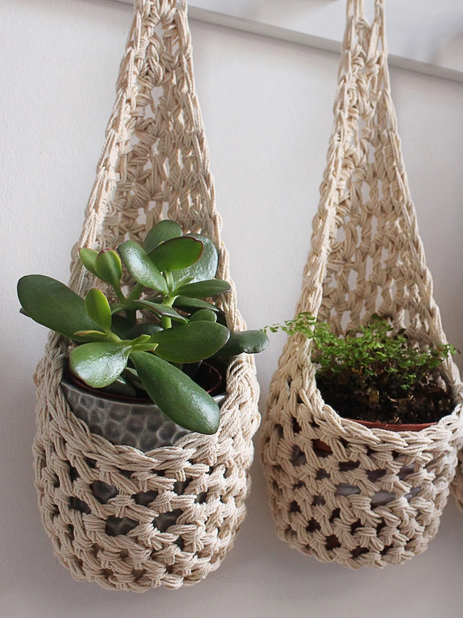cream ivory indoor hanging wall planter plant basket handmade porch decor crochet boho eco friendly natural plant styling, indoor small ecru jute hanging wall planter, cream fabric wall mounted plant holder, handmade crochet plant basket, handmade sustainable crochet decor, rustic natural organic homeware accessories, ivory hanging plant holder