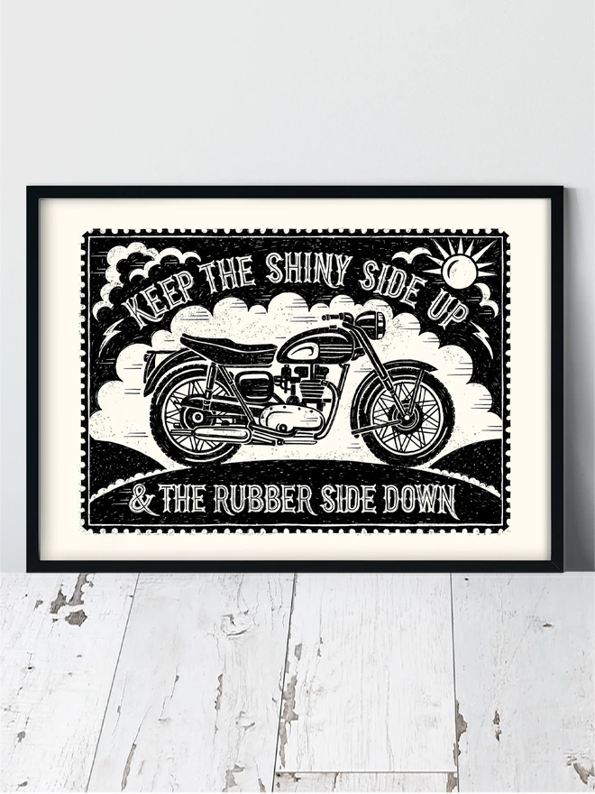 black and white motorbike print in a black frame