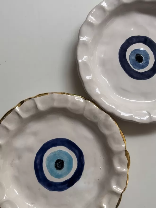 Evil Eye Chunky China Round Dinner Plate on a white table.