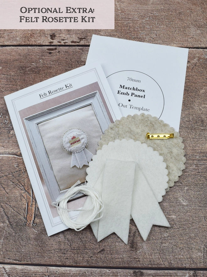 The rosette kit contents, showing instruction sheet, pattern piece, white & beige felt pieces, white yarn & gilt brooch.