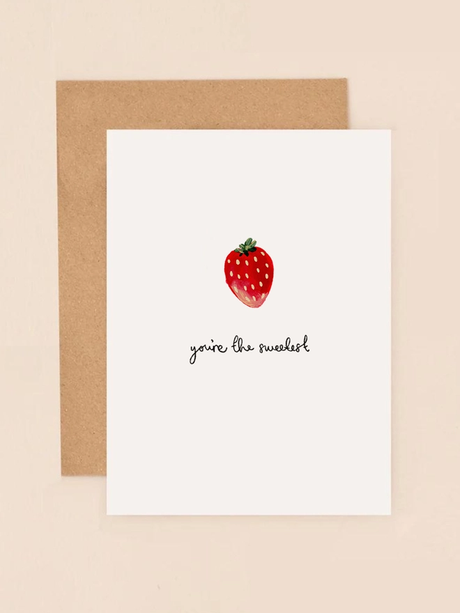 A vibrant illustration of a ripe, juicy strawberry with a subtle sheen, accompanied by the handwritten message "You're the Sweetest" in a playful, cursive font. The design features soft, pastel-colored accents and a clean, minimalist background, exuding a cheerful and heartfelt sentiment.