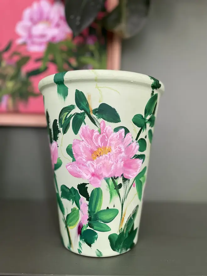 hand painted floral terracotta interior plant pot pale green background pink peony flowers