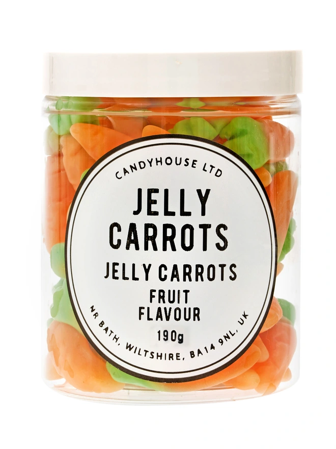 A clear jar with a white lid full of jelly carrot sweets 