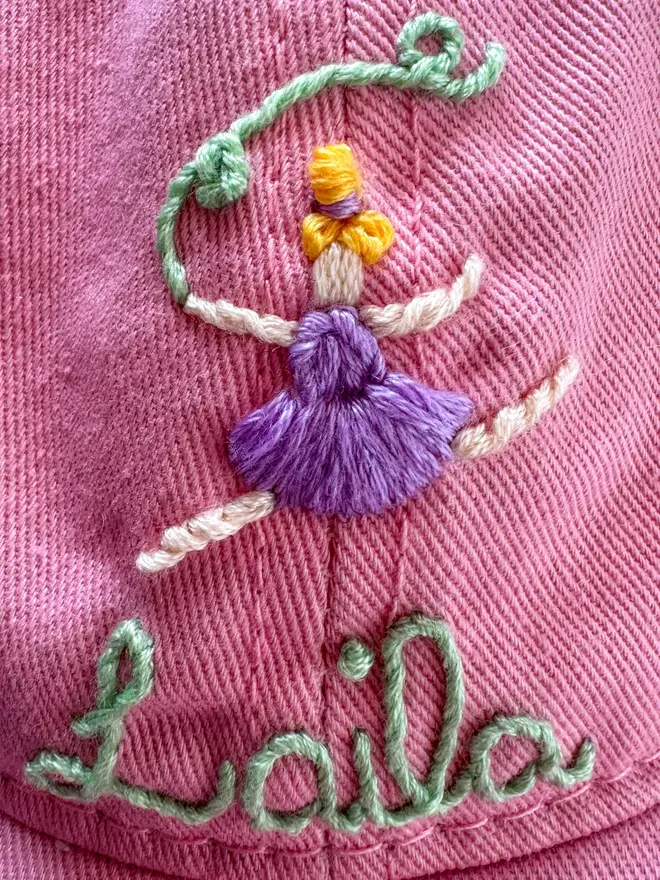 Hand Embroidered Kids Cap, a colourful personalised cap. It says a child's name. 