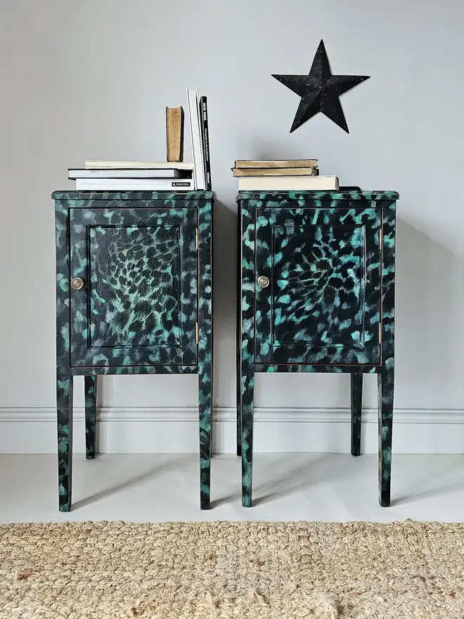 Leopard Print Handpainted and decoupaged cabinets with dark green and black colour way fading to paler green, shot shows full pieces staged with black star and monochrome books on top