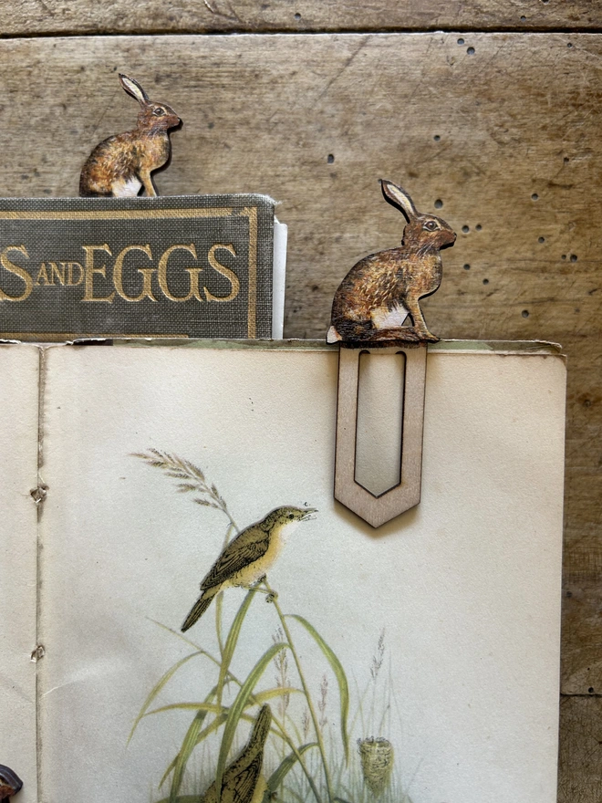 Sitting hare birch plywood paperclip bookmark attached to paper