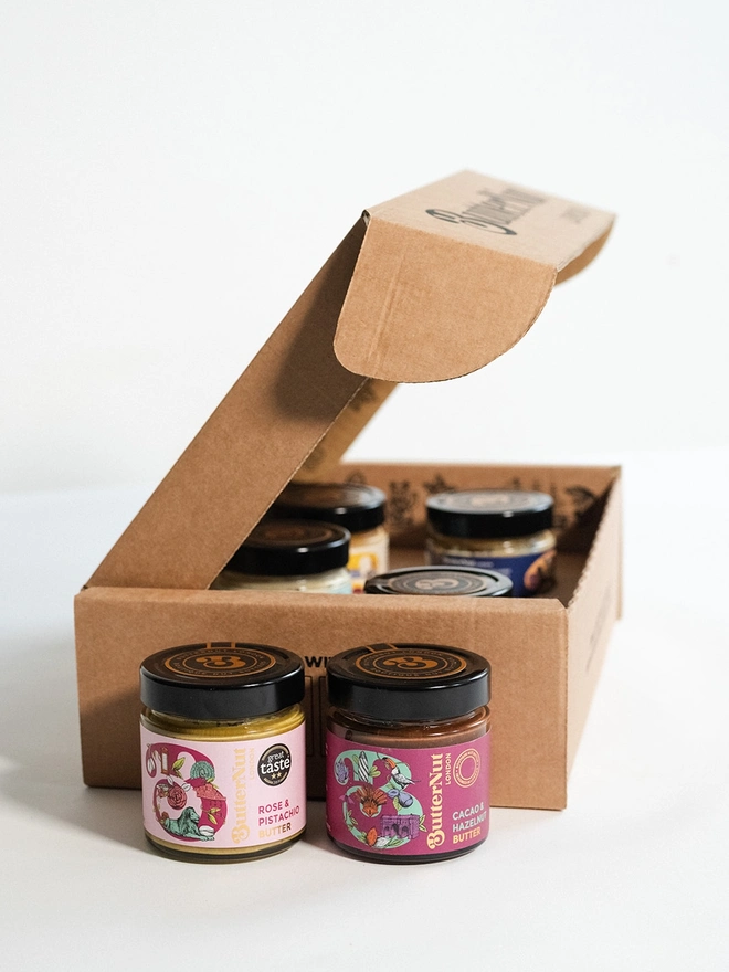 brown cardboard box full of gift set jars