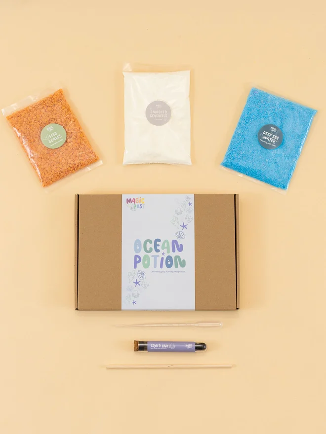 ocean mini sensory potion kit. three bags of assorted sensory materials placed around a cardboard box.