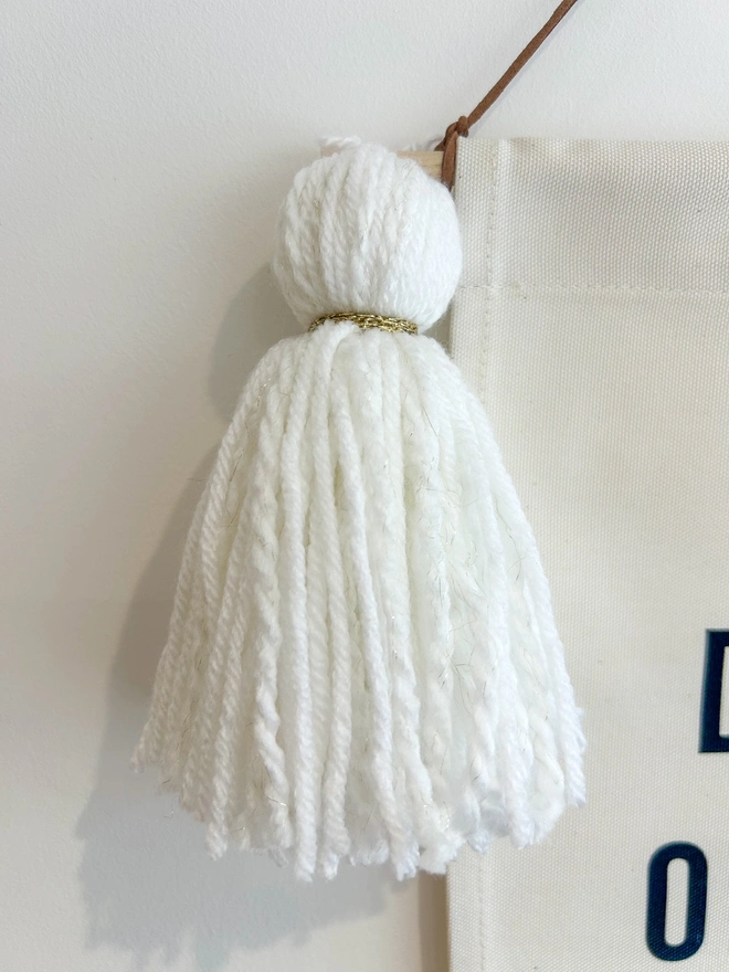 White yarn tassel with subtle sparkle